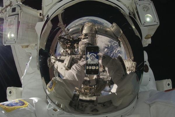 An astronaut taking a selfie. Note: This image has been digitally altered. The astronaut did take a selfie, but not with an iPhone.