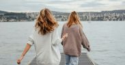 Two women walking down a pier